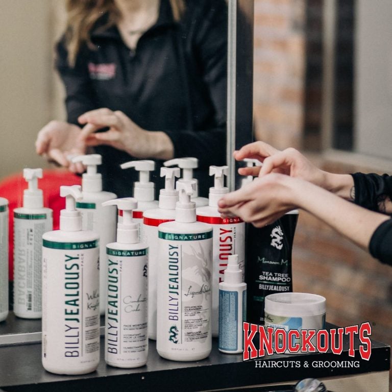 Display of Billy Jealousy essential men's grooming products including face wash, moisturizer, and shampoo at Knockouts Haircuts & Grooming
